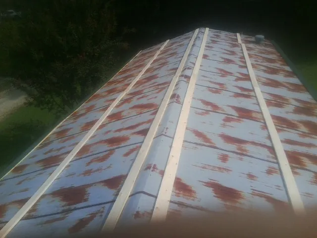 Rusted metal roof panels with new wood purlins before replacement — Storm Damage Roof Repair in Fort Gaines by Roofing Brothers